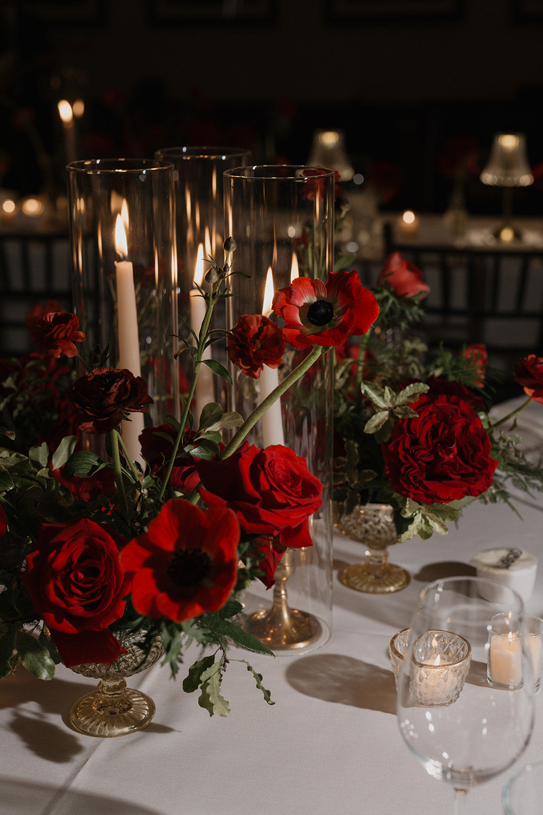 Red Roses, Anemones & butterfly ranunculus with taper candles